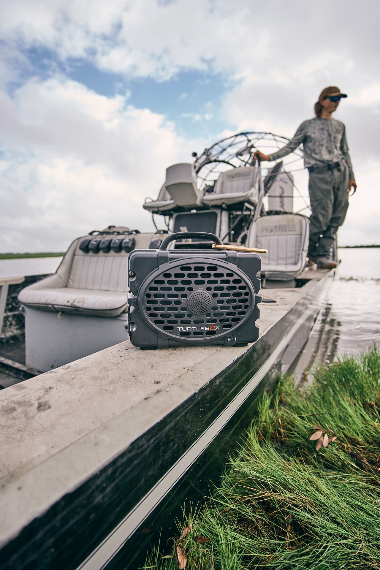 A lifestyle photo of a Original Gen 3 in gray in a boat. #speaker-color_gray
